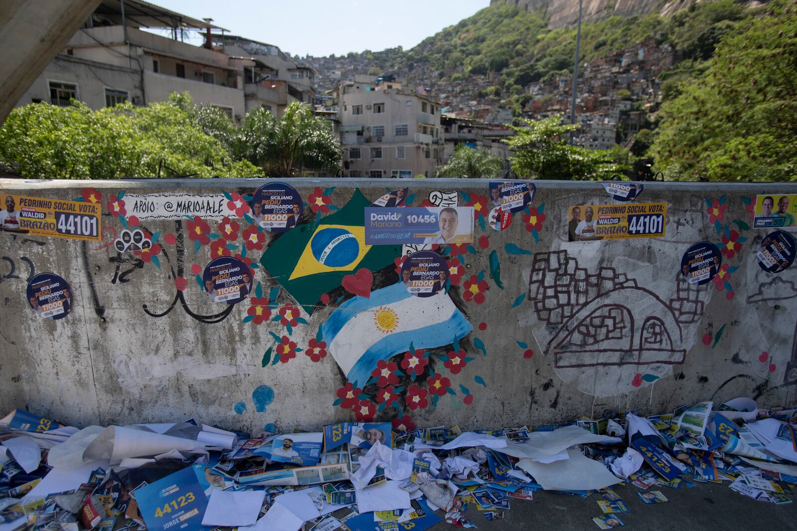 Leaflets for candidates in the municipal elections lie scattered in the Rocinha community of Rio de Janeiro, Sunday, Oct. 6, 2024. (AP Photo/Bruna Prado)