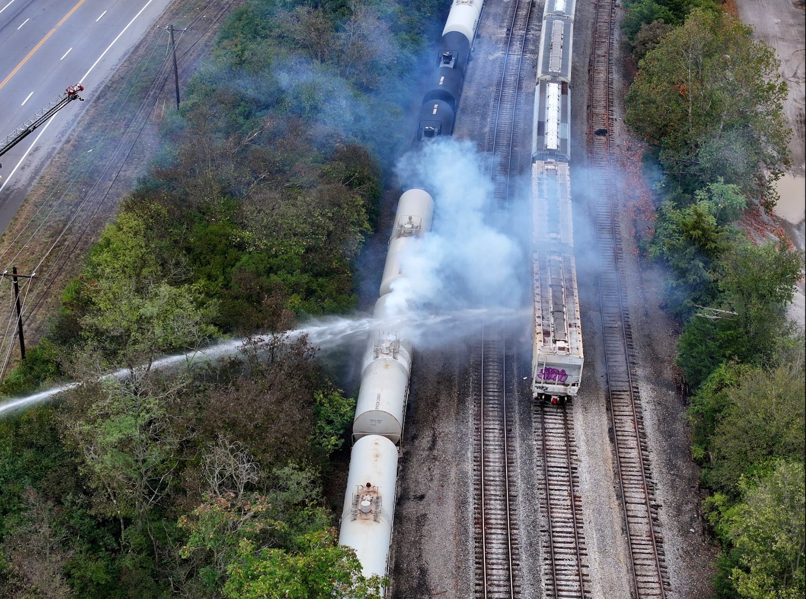 Firefighters work on the scene of a chemical leak in railcars near Cleves, Ohio, Tuesday, Sept. 24, 2024. (Local 12/WKRC via AP)