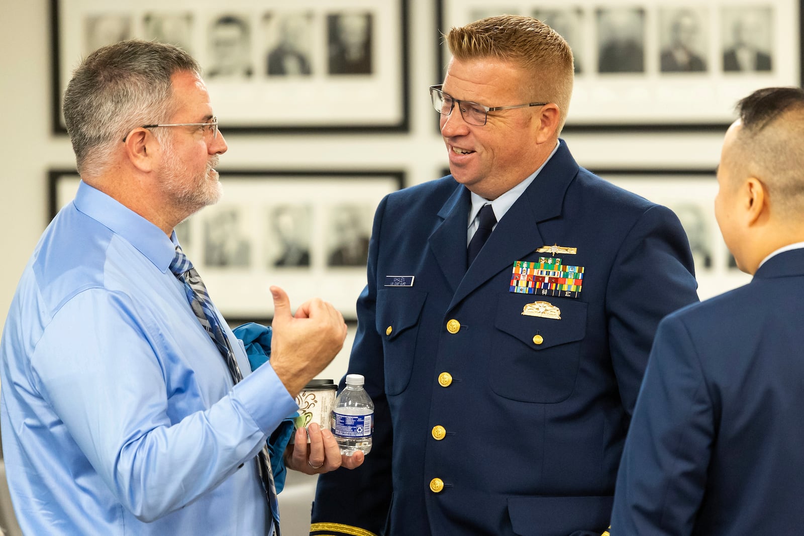 Matthew McCoy, at left, a former OceanGate employee, talks with the Coast Guard's Thomas Whalen after testimony ended during the final day of the Coast Guard investigatory hearing on the causes of the implosion of an experimental submersible headed for the wreck of the Titanic, Friday, Sept. 27, 2024, in North Charleston, S.C. (AP Photo/Mic Smith)