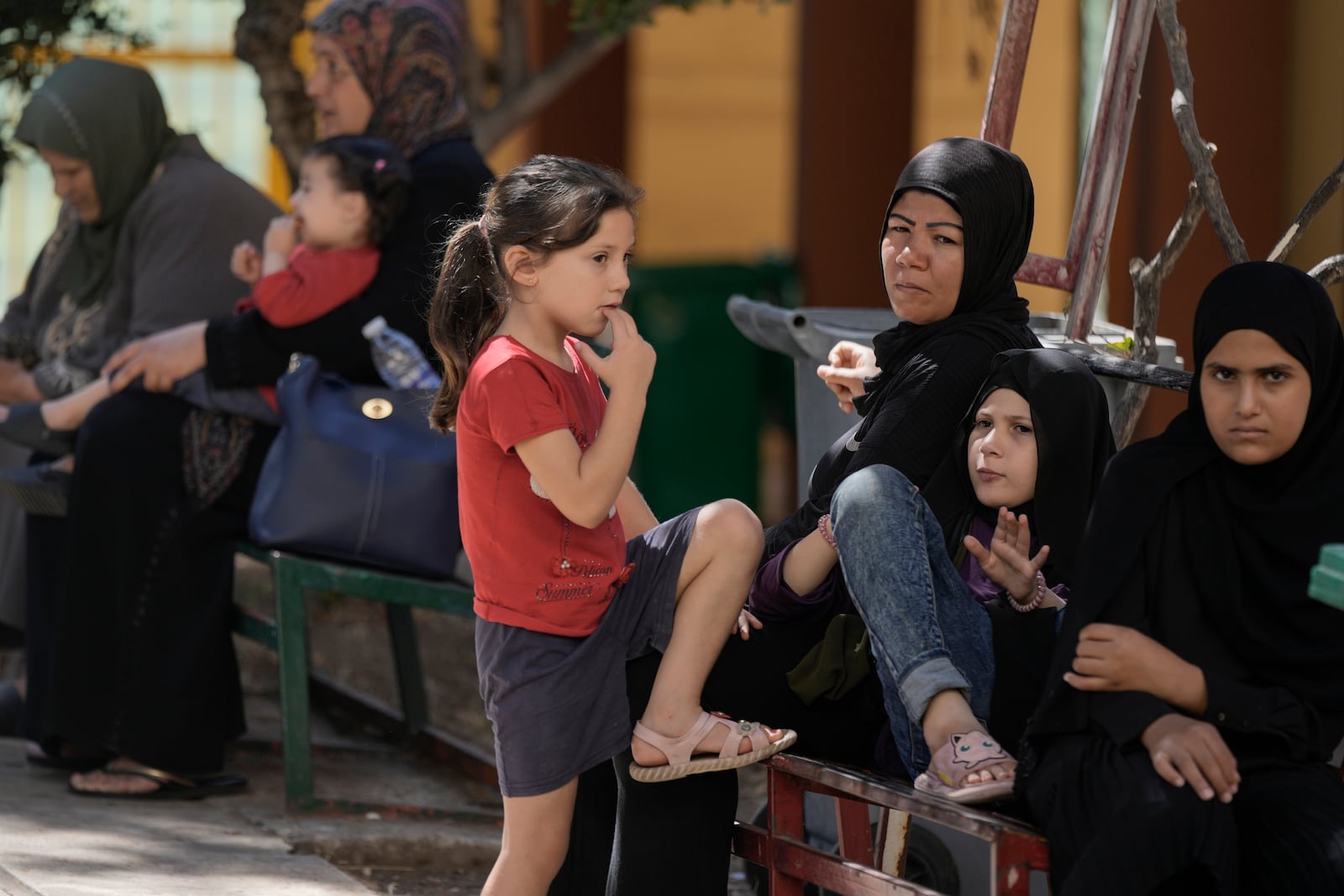 Displaced people sit at a vocational training center run by the U.N. agency for Palestinian refugees, or UNRWA, in the southern town of Sebline, south of Beirut, Lebanon, Friday, Oct. 4, 2024, after fleeing the Israeli airstrikes in the south. (AP Photo/Bilal Hussein)