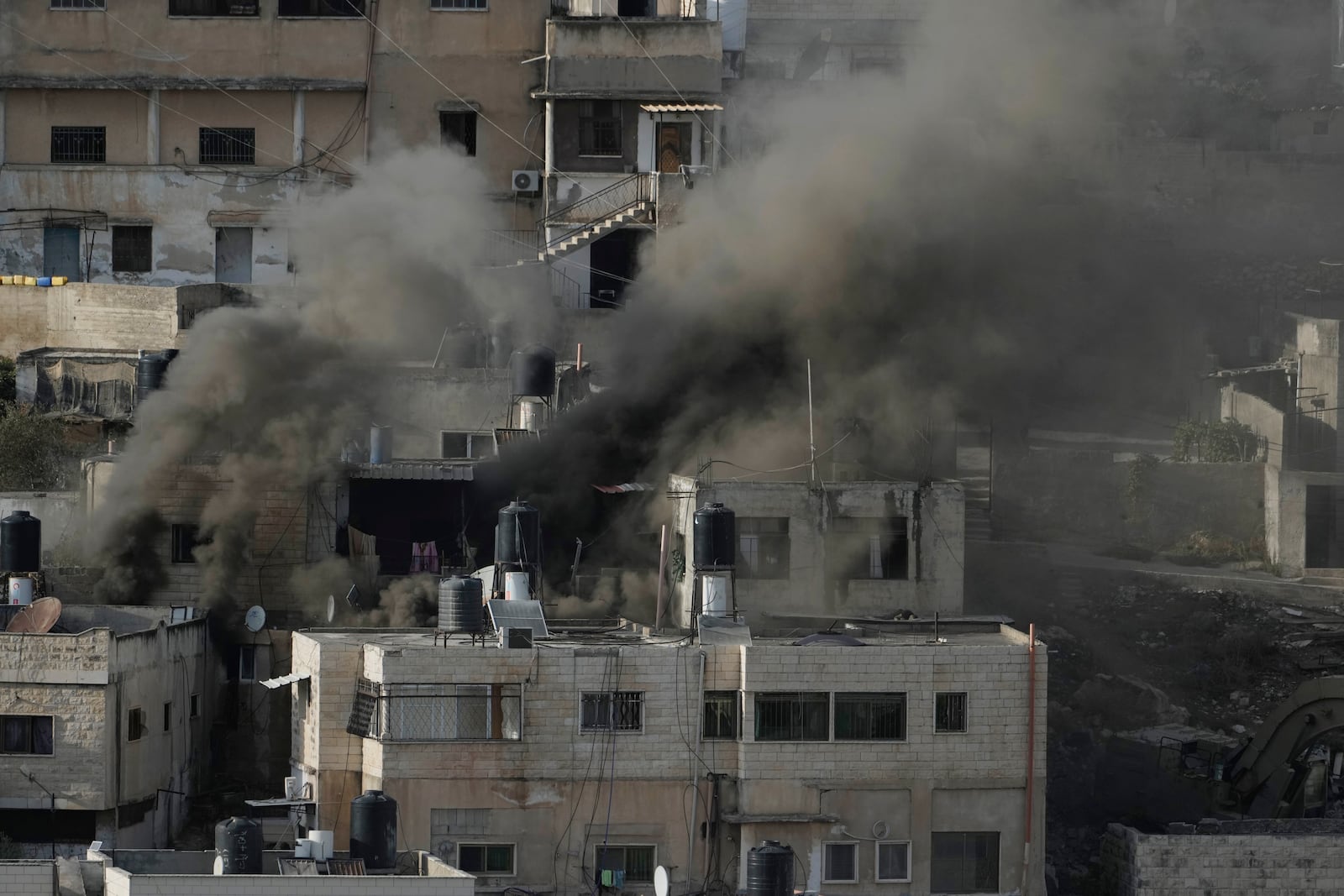 Houses are engulfed in fire as the Israeli army raided the northern West Bank town of Qatabiya on Thursday, Sept. 19, 2024. (AP Photo/Majdi Mohammed)