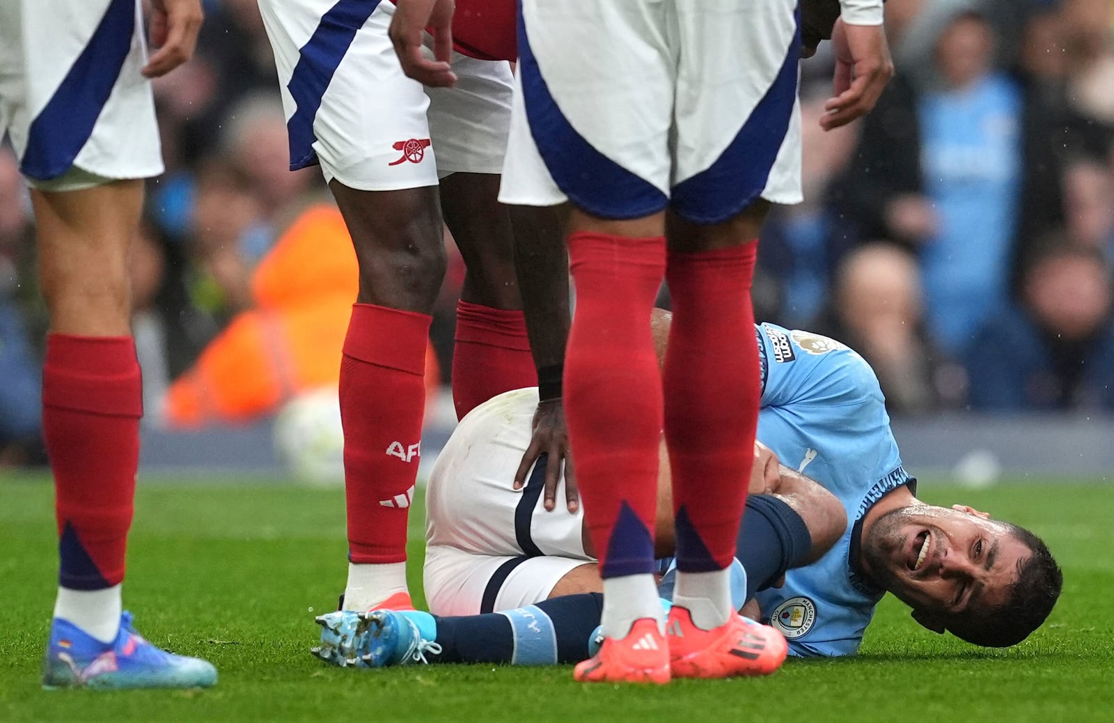 Manchester City's Rodri reacts to an injury, during the English Premier League soccer match between Manchester City and Arsenal at the Etihad stadium in Manchester, England, Sunday, Sept. 22, 2024. (Martin Rickett/PA via AP)