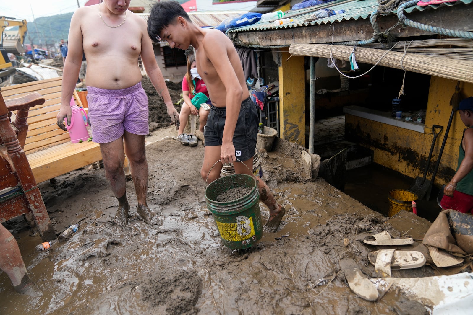 Residents clear out mud from their homes after a recent landslide triggered by Tropical Storm Trami struck Talisay, Batangas province, Philippines leaving thousands homeless and several villagers dead on Saturday, Oct. 26, 2024. (AP Photo/Aaron Favila)