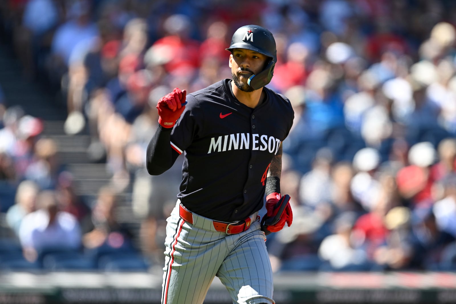 Minnesota Twins' Carlos Correa celebrates drawing a walk during the first inning of a baseball game against the Cleveland Guardians, Thursday, Sept. 19, 2024, in Cleveland. (AP Photo/Nick Cammett)