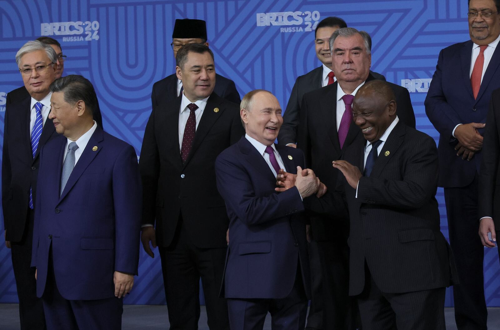 Russian President Vladimir Putin, center, and South African President Cyril Ramaphosa laugh during a family photo ceremony prior to Outreach/BRICS Plus format session at BRICS Summit in Kazan, Russia, Thursday, Oct. 24, 2024. (Alexander Nemenov, Pool Photo via AP)