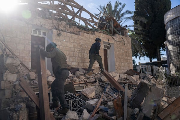 Israeli security forces check a house hit by a rocket fired from Lebanon on Saturday, in Haifa, Israel, Sunday, Nov. 17, 2024. (AP Photo/Ohad Zwigenberg)