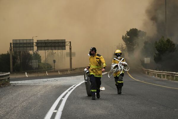 Israeli firefighters work to extinguish a forest fire burning near Jerusalem, Wednesday, April 30, 2025. (AP Photo/Mahmoud Illean)