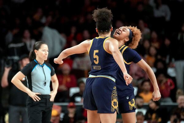 Notre Dame guards Olivia Miles (5) and Hannah Hidalgo celebrate during the second half of an NCAA college basketball game against Southern California, Saturday, Nov. 23, 2024 in Los Angeles. (AP Photo/Eric Thayer)