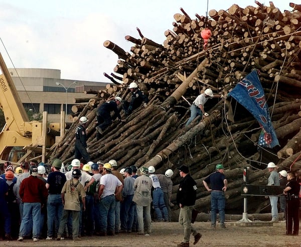 FILE - Texas A&M students and rescue workers gather at the base of the collapsed bonfire stack as the search continues for victims Nov. 18, 1999, in College Station, Texas. (AP Photo/Pat Sullivan, File)