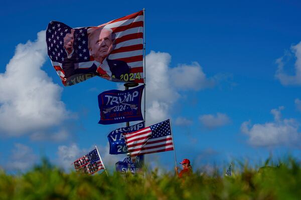 FILE - Supporters display flags near the Mar-a-Lago estate of President-elect Donald Trump, in Palm Beach, Fla. Nov. 12, 2024. (AP Photo/Julia Demaree Nikhinson, File)