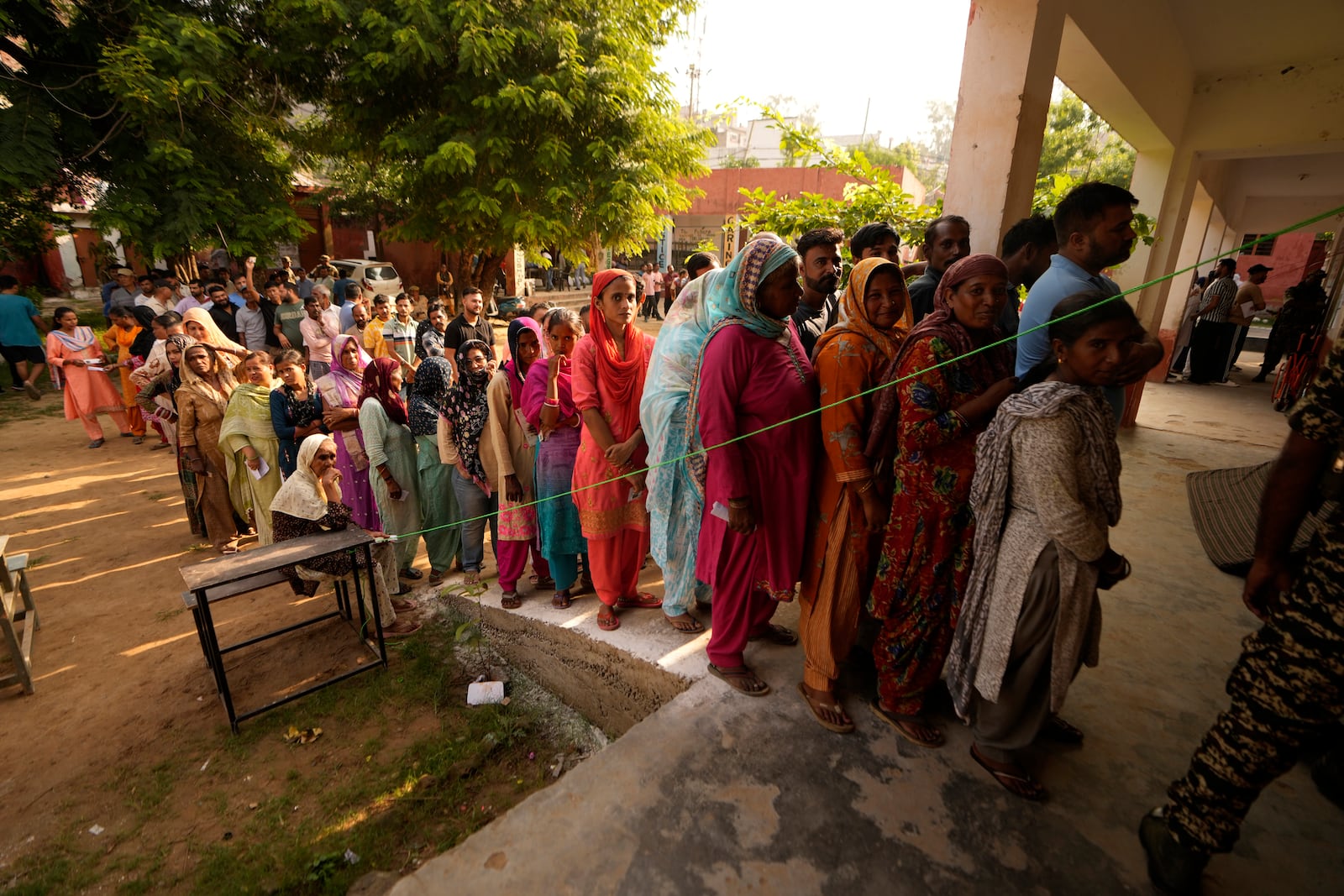 People queue up to cast their vote at a polling booth during the third phase of the Jammu and Kashmir Assembly election in Jammu, India, Tuesday, Oct. 1, 2024. (AP Photos/Channi Anand)