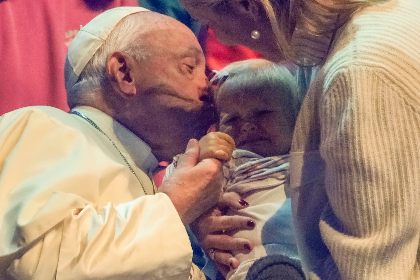 Pope Francis kisses a child during the Hope Happening youth festival at the Brussels Expo, Belgium, Saturday, Sept. 28, 2024, on the third day of his four-day visit to Luxembourg and Belgium. (AP Photo/Andrew Medichini)