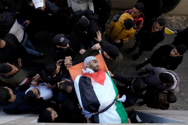 Mourners carry the body of Nour Arafat, 18, killed in clashes by an Israeli soldier Monday and claimed by Hamas as one of its militant fighters, during his funeral in the West Bank city of Nablus, Tuesday, Nov. 19, 2024. (AP Photo/Majdi Mohammed)