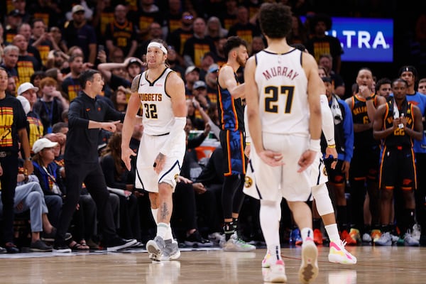Denver Nuggets' Aaron Gordon (32) and Jamal Murray (27) celebrate after Gordon sunk a shot late in the second half of Game 1 of an NBA basketball second-round playoff series against the Oklahoma City Thunder Monday, May 5, 2025, in Oklahoma City. (AP Photo/Nate Billings)