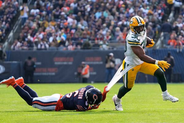 Chicago Bears' Kyler Gordon tries to stop Green Bay Packers' Chris Brooks during the first half of an NFL football game Sunday, Nov. 17, 2024, in Chicago. (AP Photo/Nam Y. Huh)