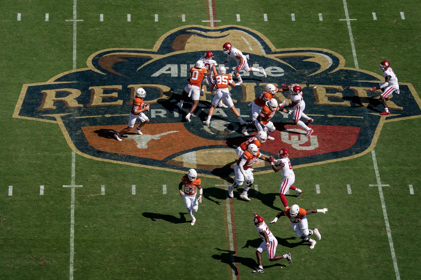 FILE - Texas quarterback Quinn Ewers, left, drops back to pass against Oklahoma during the first half of an NCAA college football game at the Cotton Bowl, Saturday, Oct. 7, 2023, in Dallas. (AP Photo/Jeffrey McWhorter, File)