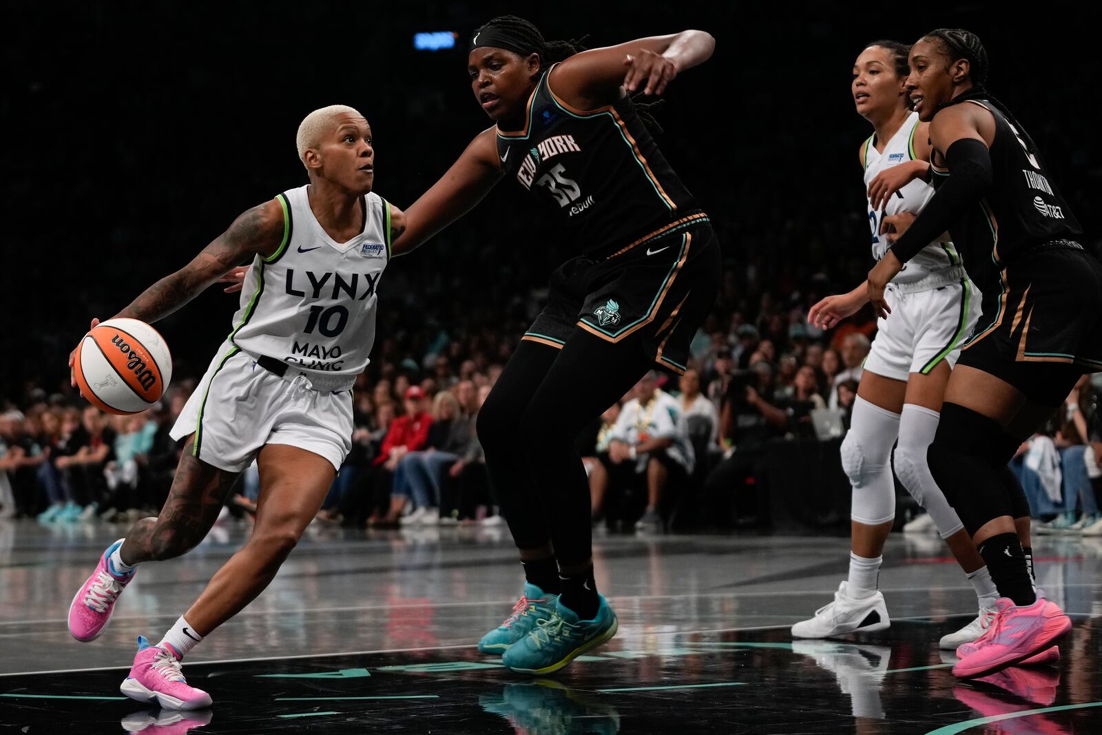 Minnesota Lynx guard Courtney Williams (10) drives against New York Liberty forward Jonquel Jones (35) during the third quarter of Game 5 of the WNBA basketball final series, Sunday, Oct. 20, 2024, in New York. (AP Photo/Pamela Smith)