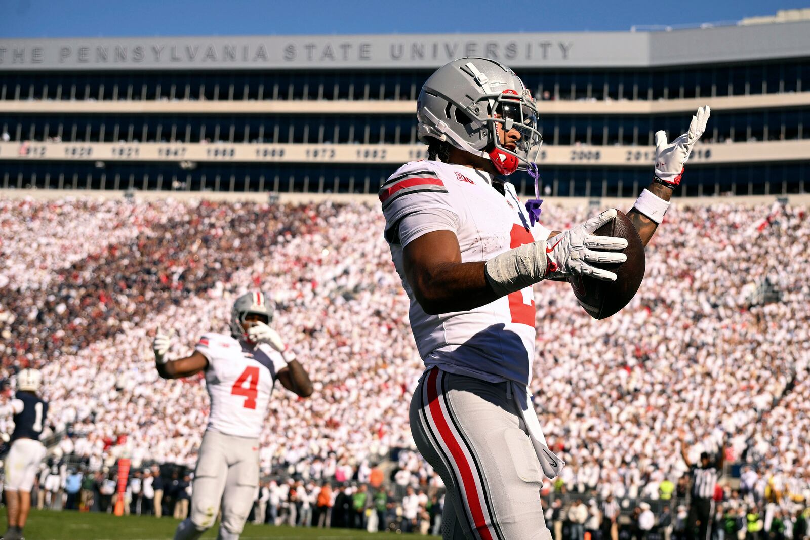 Ohio State wide receiver Emeka Egbuka (2) celebrates a touchdown reception against Penn State during the first quarter of an NCAA college football game, Saturday, Nov. 2, 2024, in State College, Pa. (AP Photo/Barry Reeger)