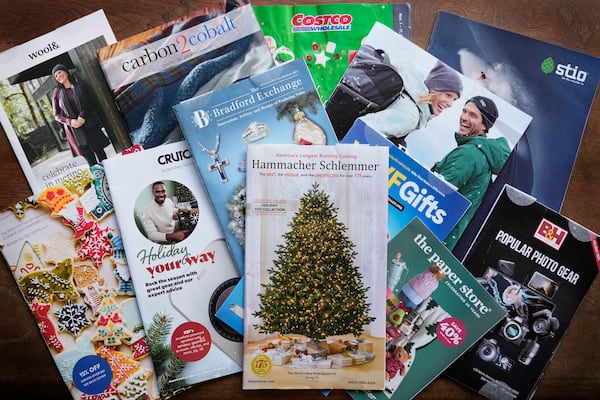 A collection of 2024 holiday catalogs are displayed Monday, Nov. 25, 2024, in Freeport, Maine. Catalog retailers, reeling from U.S. postal rate increases, have responded with pint-sized catalogs this holiday season. (AP Photo/Robert F. Bukaty)