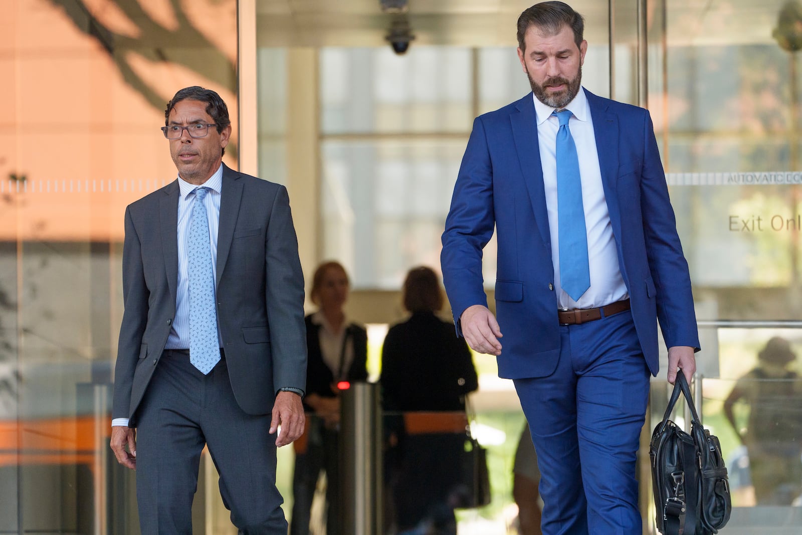 Dr. Mark Chavez, left, a physician from San Diego, who is charged in connection with Matthew Perry's fatal overdose, walks out of the United States Courthouse with his with his defense attorney Matthew Binninger after pleading guilty to conspiring to distribute the surgical anesthetic ketamine in Los Angeles on Wednesday, Oct. 2, 2024. (AP Photo/Damian Dovarganes)