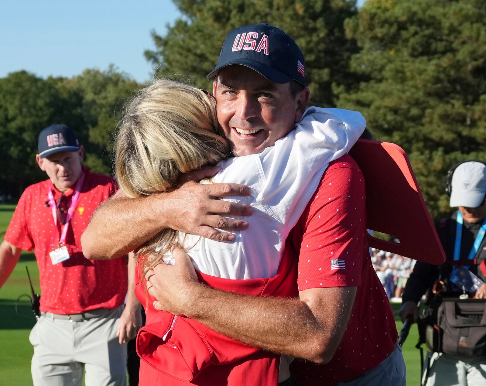 United States team member Keegan Bradley, right, hugs his wife Jillian Stacey after winning the Presidents Cup golf tournament at Royal Montreal Golf Club, Sunday, Sept. 29, 2024, in Montreal. (Nathan Denette/The Canadian Press via AP)