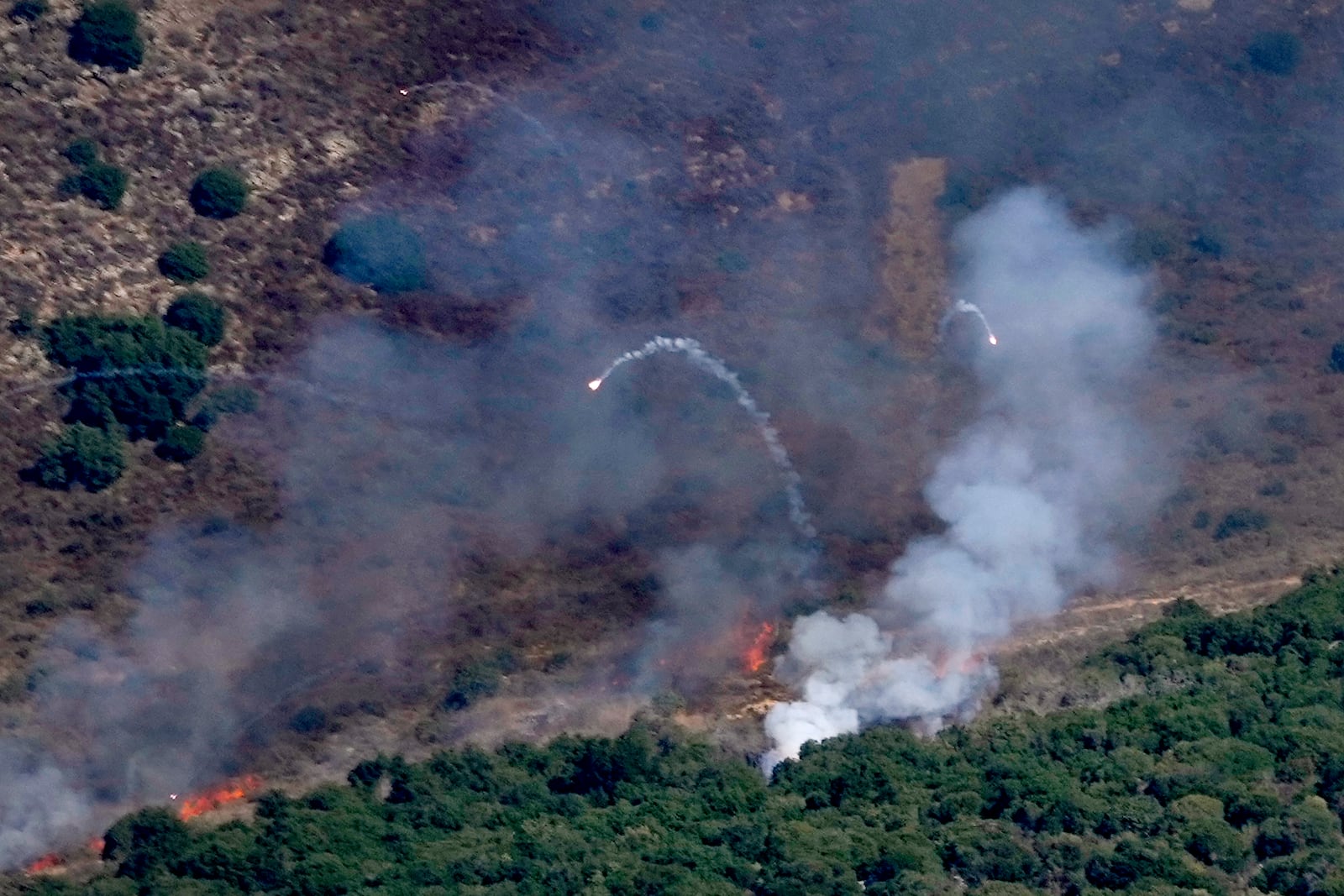 Flames and smoke rise from an Israeli airstrike on Mahmoudieh mountain, as seen from Marjayoun town, south Lebanon, Tuesday, Sept. 24, 2024. (AP Photo/Hussein Malla)