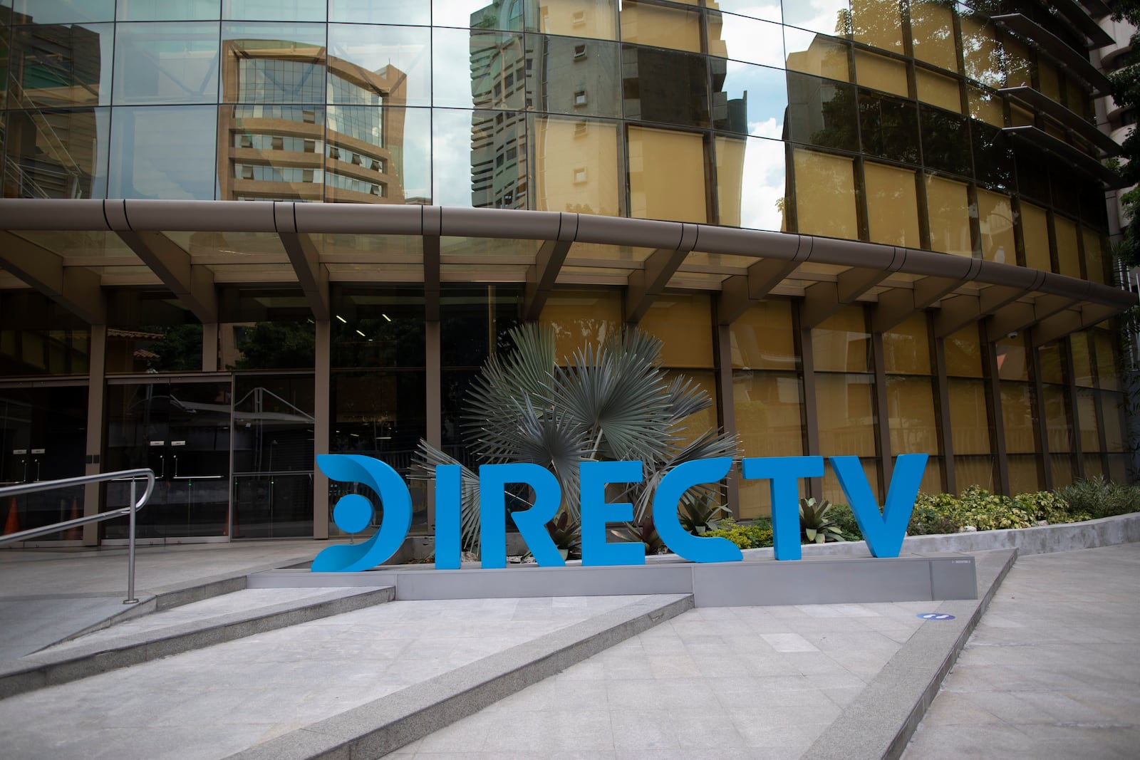 FILE - A DirectTV logo identifies the company's headquarters in Caracas, Venezuela, Friday, May 22, 2020. (AP Photo/Ariana Cubillos, File)