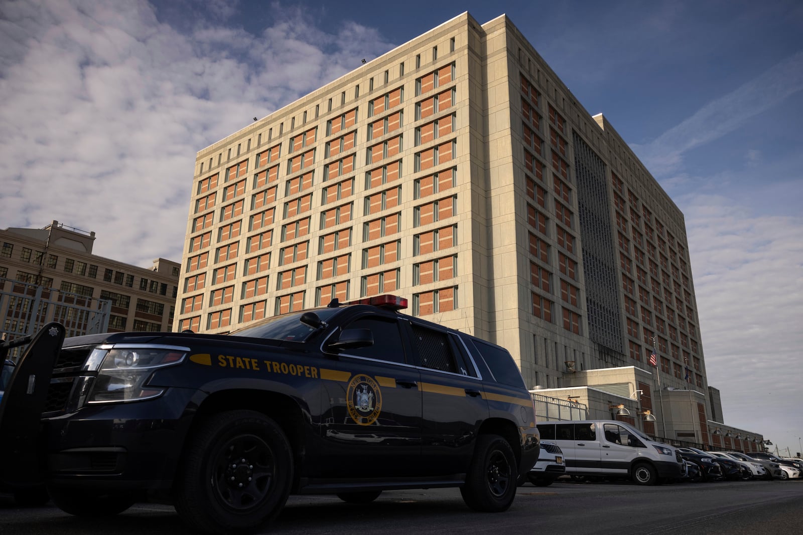 A state trooper vehicle is parked outside the Metropolitan Detention Center during the interagency operation, Monday, Oct. 28, 2024, in the Brooklyn Borough of New York. (AP Photo/Yuki Iwamura)