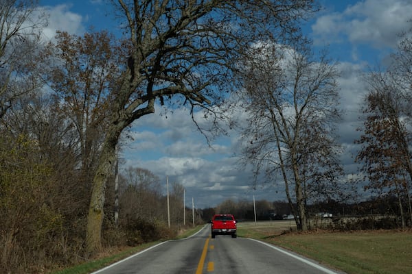 Erin and Mike Young drive to the Trenton Township building to vote with their adopted kids, Gianna, 7, Isaac, 5, and Lucas, 8, on Election Day, Tuesday, Nov. 5, 2024, in Sunbury, Ohio. (AP Photo/Carolyn Kaster)