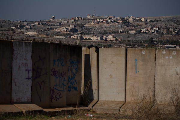 Damaged buildings stand on an area in southern Lebanon, during the ceasefire between Israel and Hezbollah, as seen from the northern Israel, Saturday, Nov. 30, 2024. (AP Photo/Leo Correa)