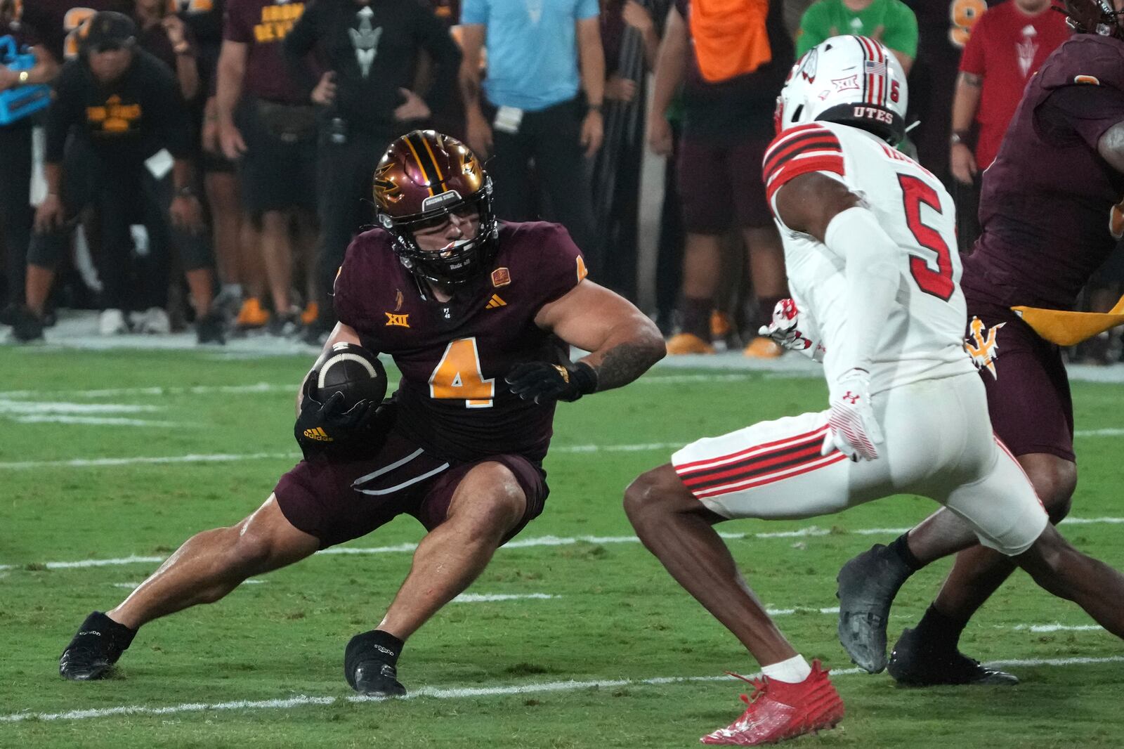 Arizona State running back Cam Skattebo avoids Utah cornerback Zemaiah Vaughn (5) in the first half during an NCAA college football game, Friday, Oct. 11, 2024, in Tempe, Ariz. (AP Photo/Rick Scuteri)