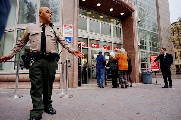 A Los Angeles County sheriff's deputy maintains a perimeter around the Van Nuys courthouse for the hearing for Erik and Lyle Menendez in Los Angeles, Monday, Nov. 25, 2024. (AP Photo/Damian Dovarganes)