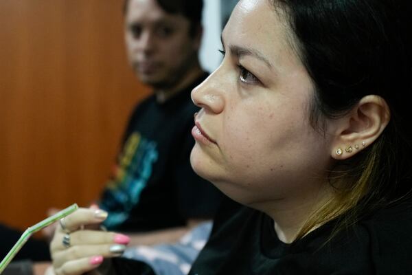 Susana Moreira, 41, a degenerative muscular dystrophy patient, gives an interview in her bedroom in Santiago, Chile, Monday, April 7, 2025. (AP Photo/Esteban Felix)