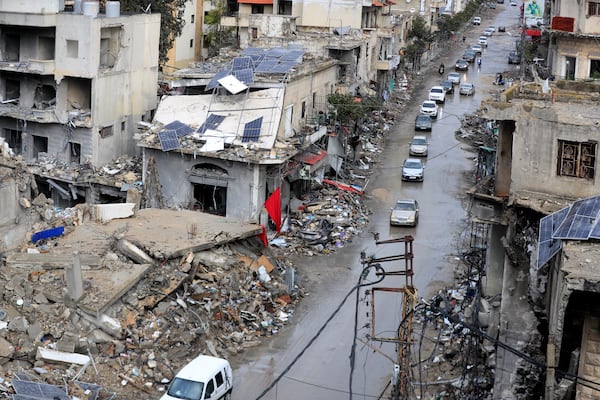 Displaced residents drive past destroyed buildings as they return to Nabatiyeh, Lebanon, after a ceasefire between Israel and Hezbollah went into effect on Wednesday, Nov. 27, 2024. (AP Photo/Mohammed Zaatari)