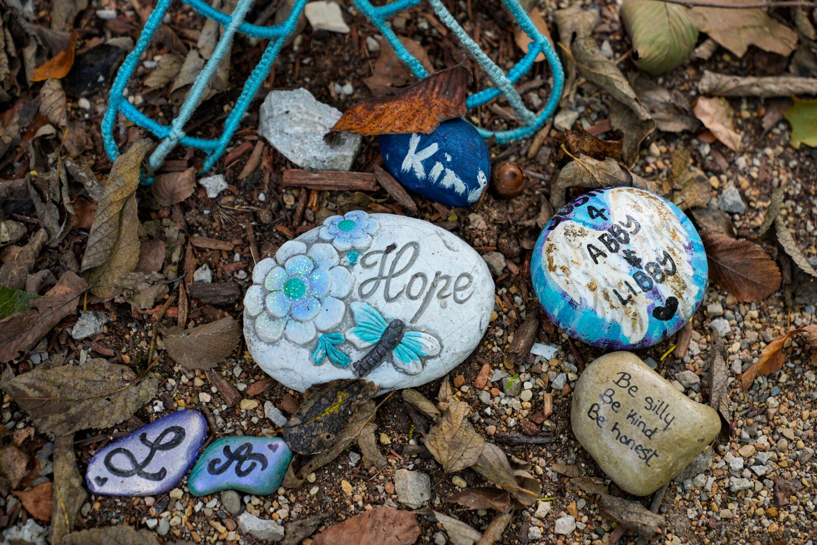 Decorated stones bearing the names of Abigail Williams and Liberty German, who were killed in February 2017, are placed at a memorial along the Monon High Bridge Trail in Delphi, Ind., Tuesday, Oct. 1, 2024. (AP Photo/Michael Conroy)