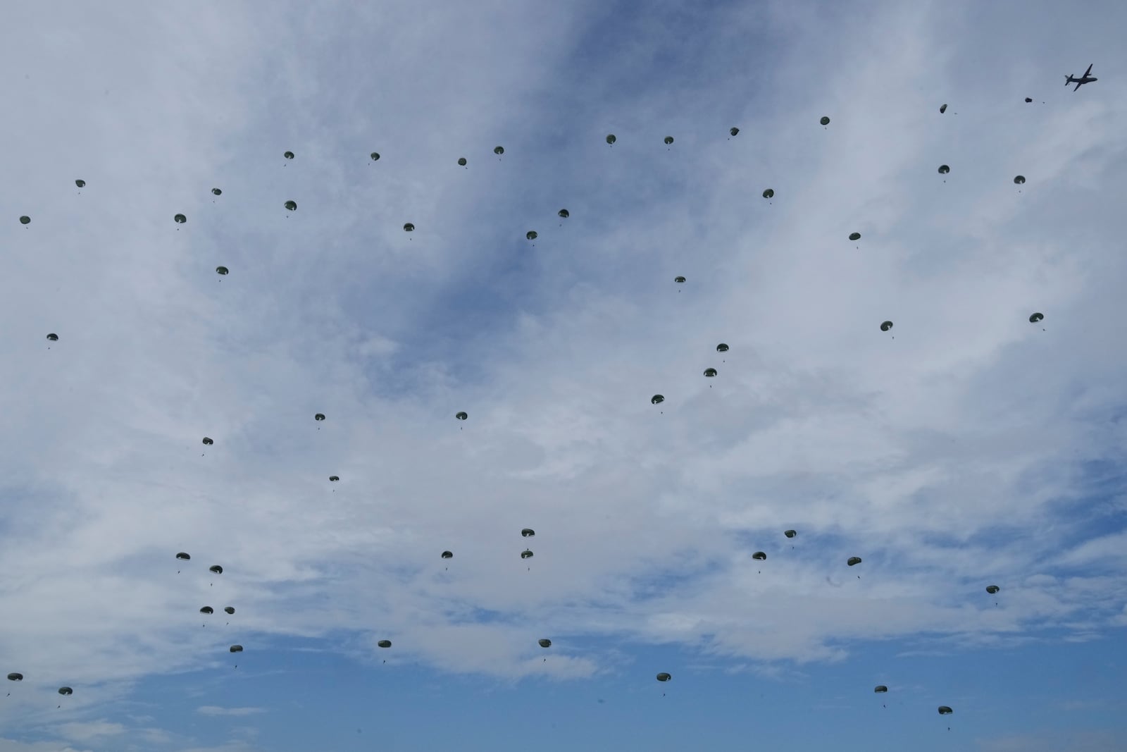 South Korean special army soldiers parachute down from a plane during the media day for the 76th anniversary of Armed Forces Day at Seoul air base in Seongnam, South Korea, Wednesday, Sept. 25, 2024. (AP Photo/Ahn Young-joon)