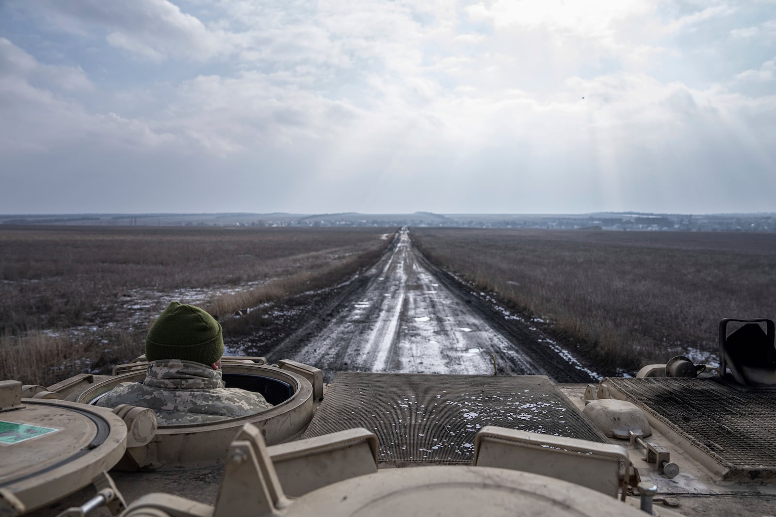 FILE - A Ukrainian serviceman of 68 Oleksa Dovbush hunting brigade drives by M113 armoured vehicle towards frontline positions near Vuhledar, Ukraine, Feb. 22, 2023. (AP Photo/Evgeniy Maloletka, File)