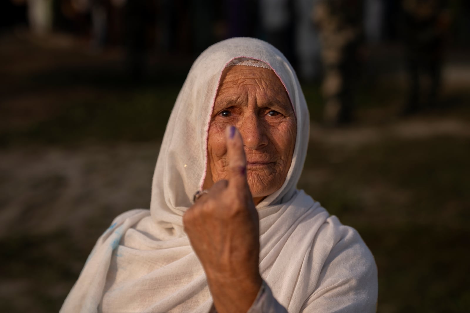 Sayeeda Begum shows the indelible ink mark on her index finger after casting her vote in the outskirts of Srinagar, Indian controlled Kashmir, Wednesday, Sept. 25, 2024. (AP Photo/Dar Yasin)