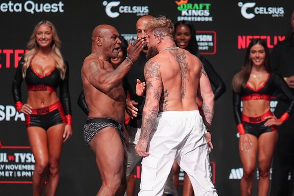 Mike Tyson, left, slaps Jake Paul during a weigh-in ahead of their heavyweight bout, Thursday, Nov. 14, 2024, in Irving, Texas. (AP Photo/Julio Cortez)