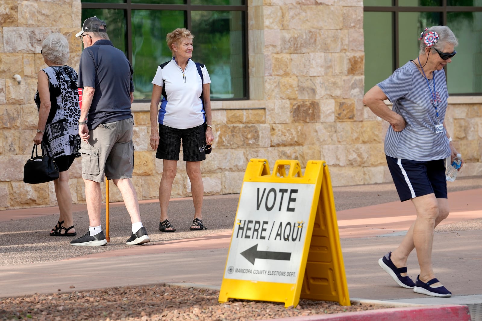 Voters arrive to vote on the first day of early in-person voting at Surprise City Hall Wednesday, Oct. 9, 2024, in Surprise, Ariz. (AP Photo/Ross D. Franklin)