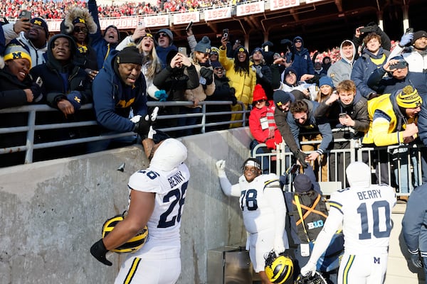 Michigan players celebrate their win over Ohio State in an NCAA college football game Saturday, Nov. 30, 2024, in Columbus, Ohio. (AP Photo/Jay LaPrete)