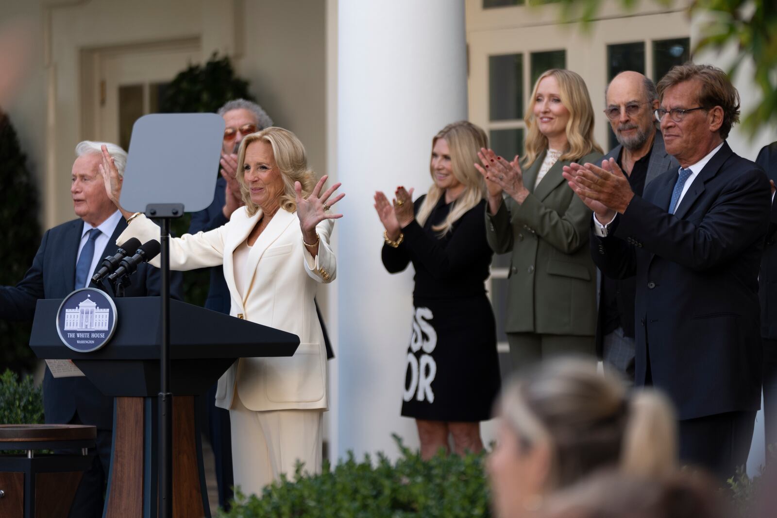 First lady Jill Biden, with actors Martin Sheen, left, Aaron Sorkin, right, and other members of the cast of The West Wing, is applauded as she hosts an event on the Rose Garden at the White House to mark the 25th anniversary of the television series, The West Wing, Friday, Sept. 20, 2024, in Washington. (AP Photo/Manuel Balce Ceneta)