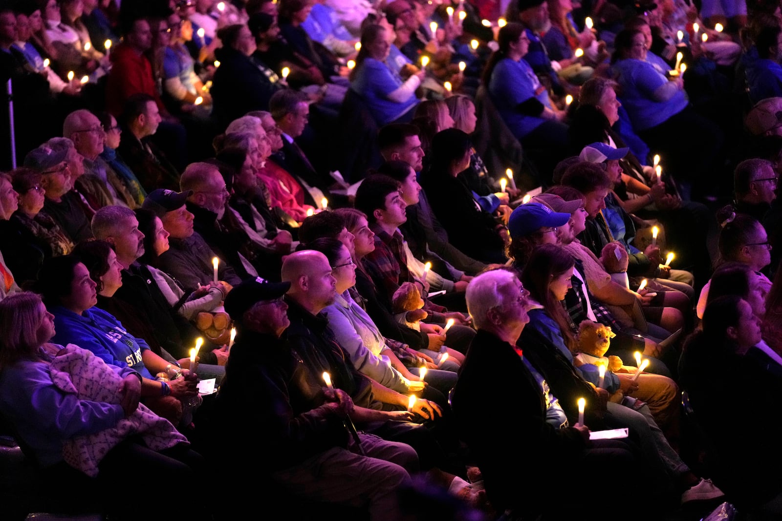 Attendees hold candle lights at a commemoration event to mark the one year anniversary of the mass shooting in Lewiston, Maine, Friday, Oct. 25, 2024. (AP Photo/Robert F. Bukaty)