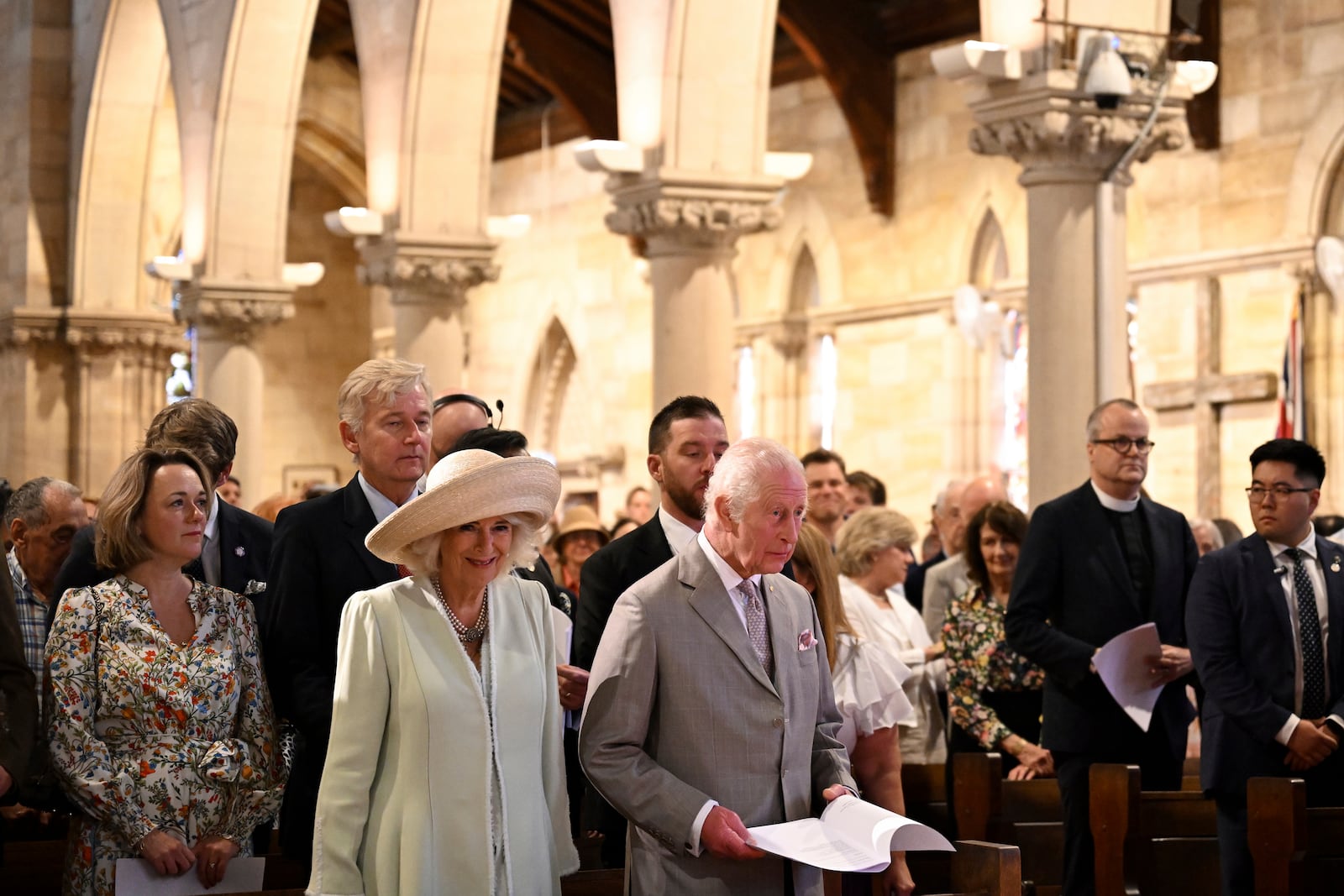 King Charles III, center right, and Queen Camilla, center left, stand during a visit to St Thomas' Anglican Church in Sydney, Sunday, Oct. 20, 2024. (Dean Lewins/Pool Photo via AP)