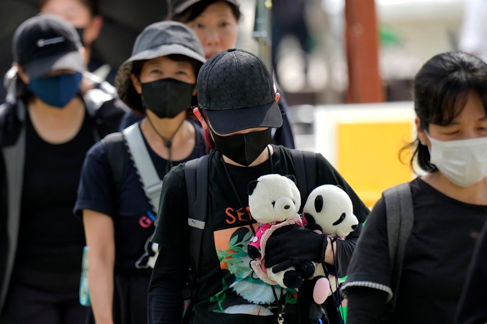 Visitors queue to see the giant pandas Ri Ri and Shin Shin at Ueno Zoo, a day before their return to China, Saturday, Sept. 28, 2024, in Tokyo. (AP Photo/Eugene Hoshiko)