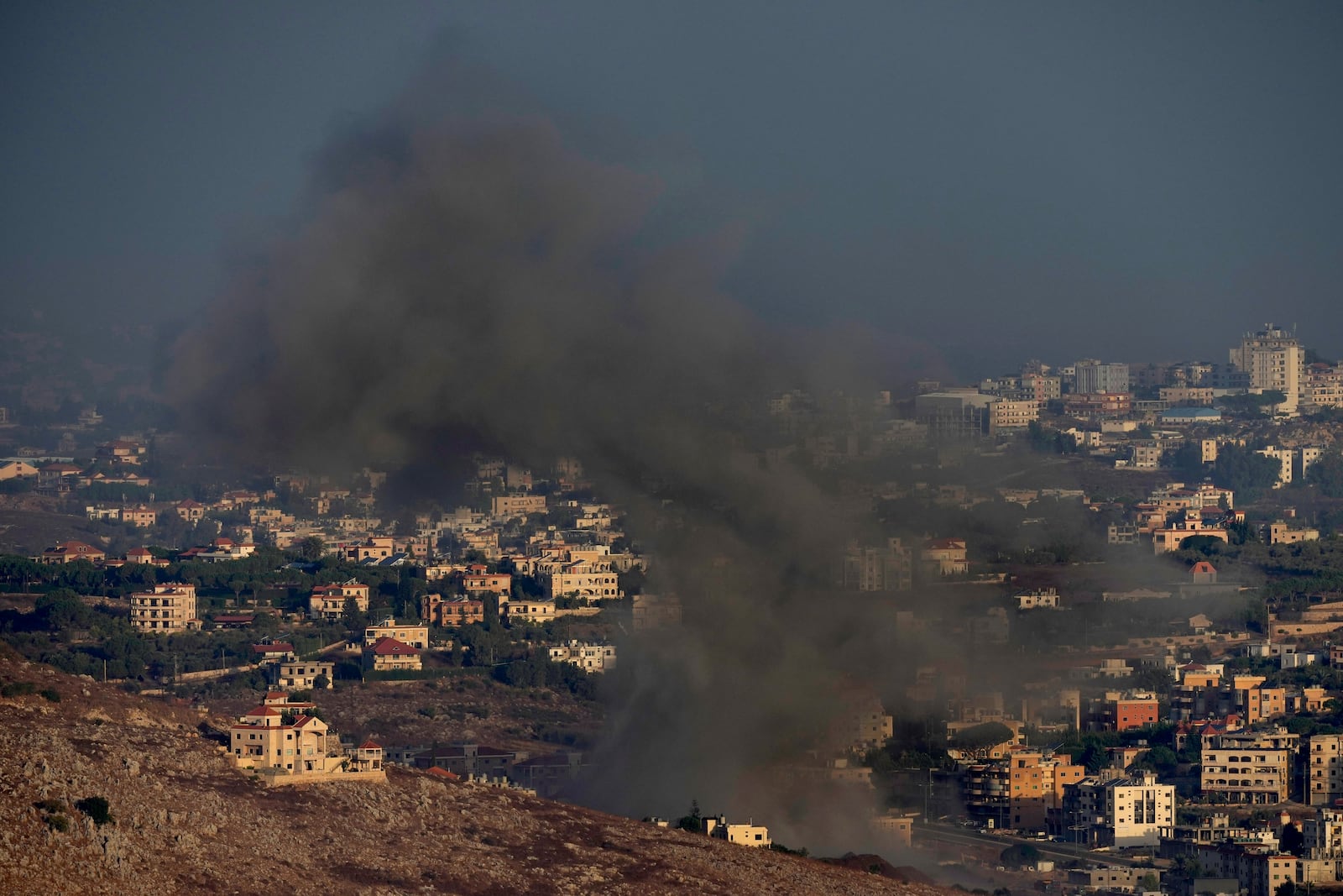 Smoke rises from an Israeli airstrike on Kfar Rouman village, as seen from Marjayoun town, south Lebanon, Monday, Sept. 23, 2024. (AP Photo/Hussein Malla)