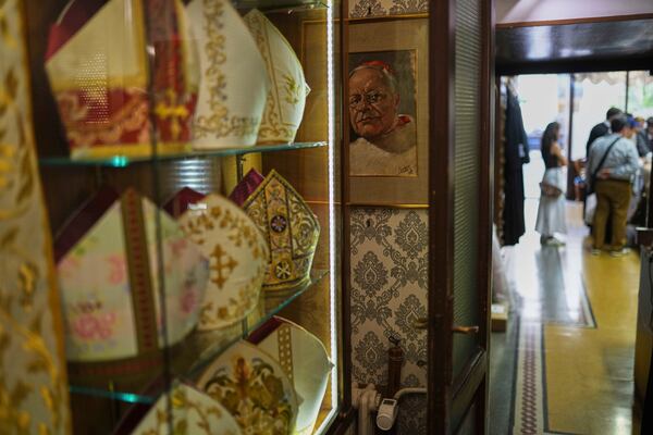 A painting hangs inside the dressing room of the Gammarelli Ecclesiastic clothes tailor shop in Rome, Wednesday, April 30, 2025. (AP Photo/Francisco Seco)
