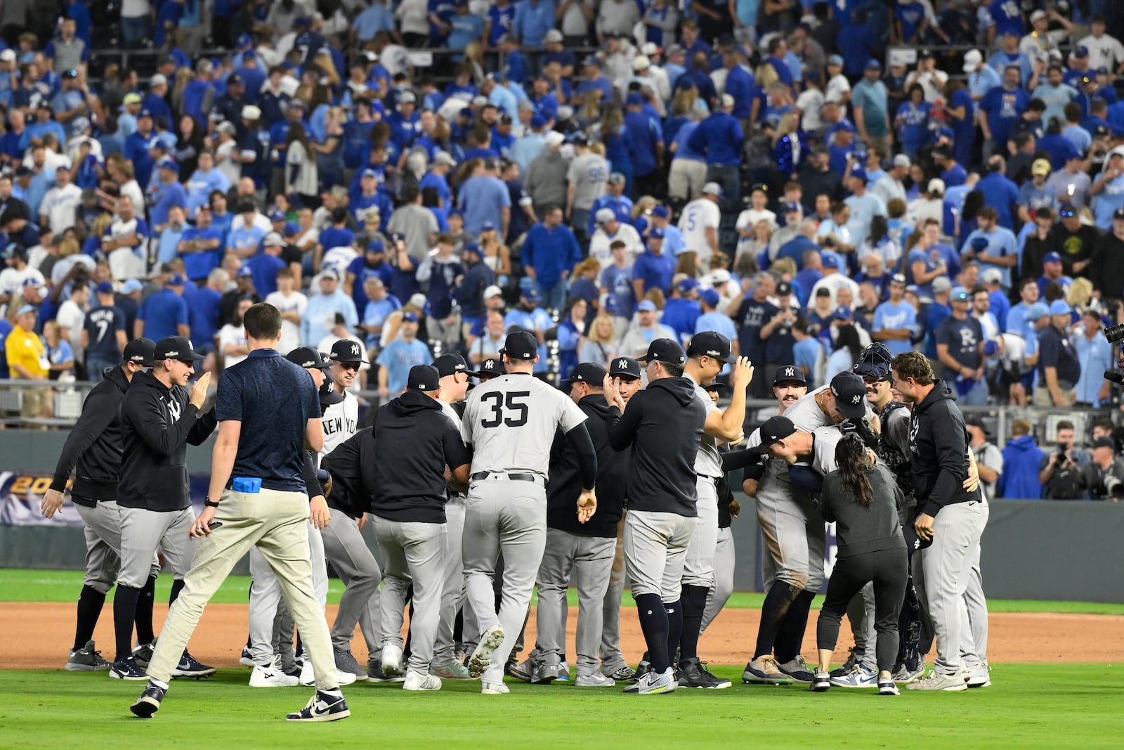 Members of the New York Yankees celebrate after defeating the Kansas City Royals 3-1 in Game 4 of an American League Division baseball playoff series and move on to the ALCS Thursday, Oct. 10, 2024, in Kansas City, Mo. (AP Photo/Reed Hoffmann)