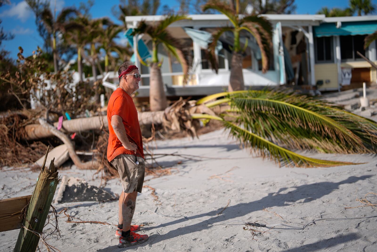 Jim Beeson, a board member of Gulf to Bay Co-Op 55+ mobile home community, surveys damage left by Hurricane Milton on Manasota Key, in Englewood, Fla., Sunday, Oct. 13, 2024. (AP Photo/Rebecca Blackwell)