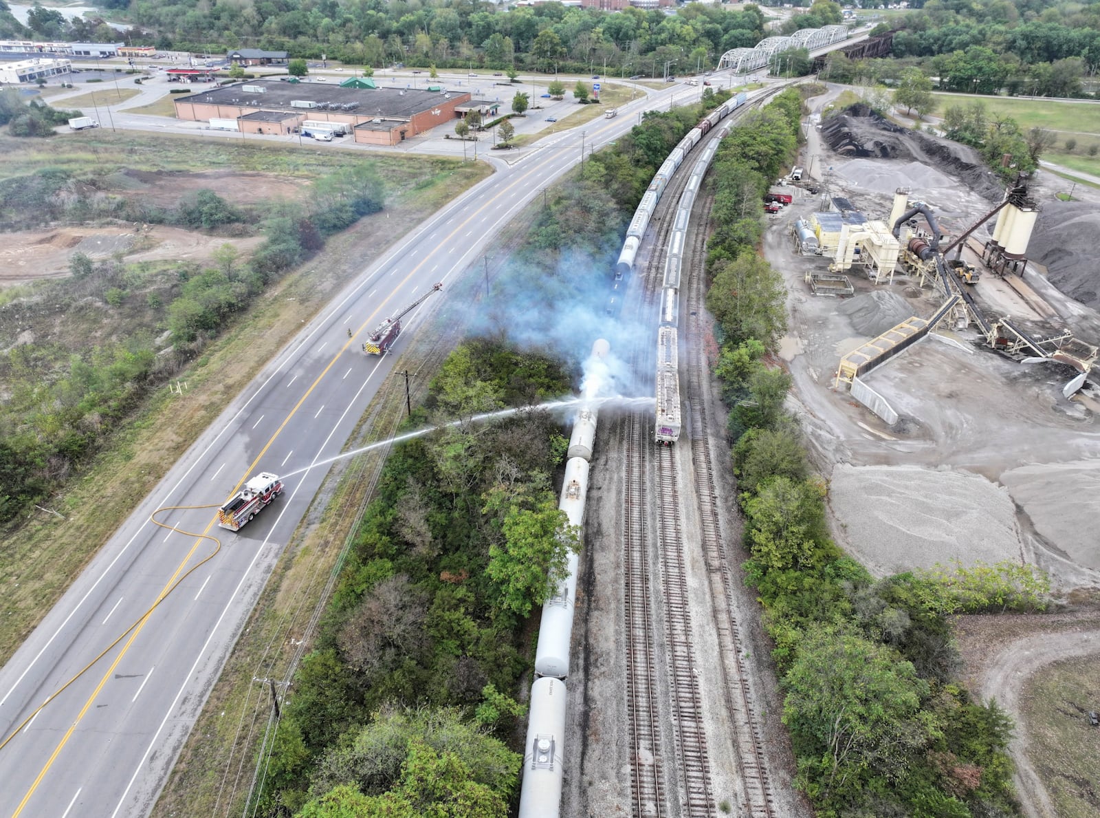 Firefighters work on the scene of a chemical leak in railcars near Cleves, Ohio, Tuesday, Sept. 24, 2024. (Local 12/WKRC via AP)